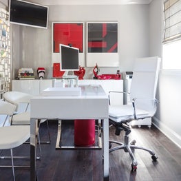 Detail shot of home office with white and red accents 