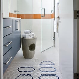 A cheerful color palette and the personalized tile in the bathroom that celebrates the family motto "Do Good" makes this a inviting space!