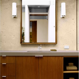 Bathroom sink with custom mirror, Kilim and concrete walls