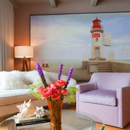 Lake Michigan Great Room. Seating area in sunrise colors with large lighthouse painting & Platner coffee table.