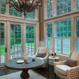 Dramatic Chandelier in this Breakfast Room accentuates the high ceiling and view