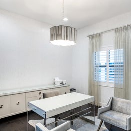 SLEEK CONTEMPORARY METALLIC RESIDENCE modern office, minimalist office, metalic sculptural pendant light, light gray midcentury modern chairs