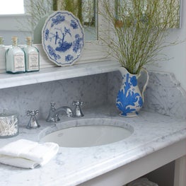A beautiful white and gray marble to a bathroom adds a fresh and crisp feel.