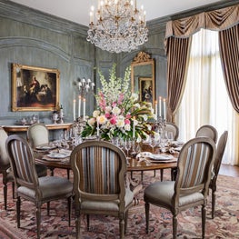 The French blue hue on the paneled walls was pulled from the antique patterned area rug.