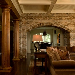 Living Room with Brick Arch, Natural Fluted Columns and Painted Wood Beams