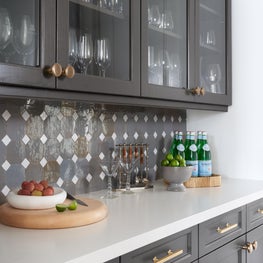 Adjacent to the dining room, this renovated butler's pantry exudes sophisticated charm and provides needed storage for entertaining essentials.