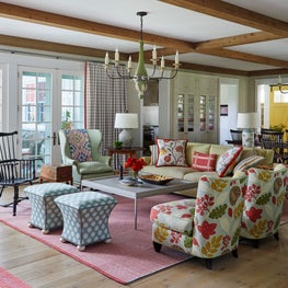 Three Barn Farm Great Room. Chic English Country style with wood beam ceiling & floral print chairs.