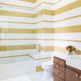 Portfolio: Horizontal stripes of gold and white tile make a bold statement in this bathroom