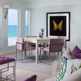  The light grey area rug defines the dining area within this larger room.