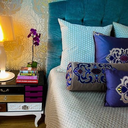 Colorful, Eclectic Master Bedroom with Custom Embroidered Pillows and Fanciful Nightstands