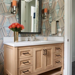 Just inside of the veranda is a pool house bath filled with personality.