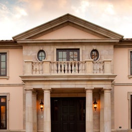 Carved stone detailing on a pedimented Italian Renaissance portico.