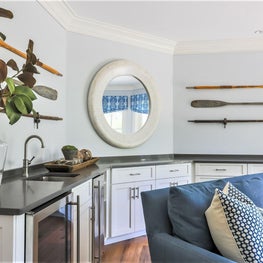 Quartz counter tops and bright white cabinets give this den a clean aesthetic. 