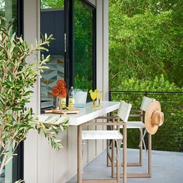 Entertaining is made easy with a bar that connects to the pool house kitchen.