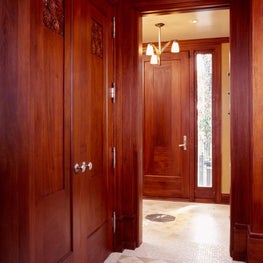 Entrance hall mahogany doors & etched glass windows feature an Art Deco motif  