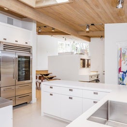 White kitchen in midcentury post and beam house