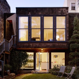 Back of home with large windows, private garden