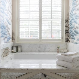 Calcutta marble, mercury glass & custom deGournay paper make this refuge sing