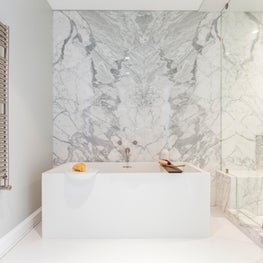 Portfolio: 1950's home renovation, marble-walled bathroom with free standing tub