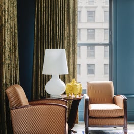 Art Deco Bedroom with teal walls, patterned silk drapes, and Chinese silk rug 