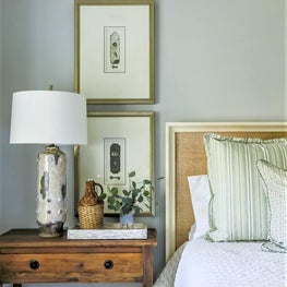 Natural elements, a rattan headboard and rustic table make this a cozy retreat