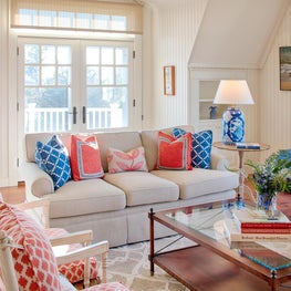 In this neutral room pops of color add to the nautical theme enhanced by the art