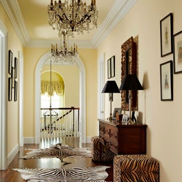 Animal prints and dark wood are contrasted against a subtle yellow backdrop.