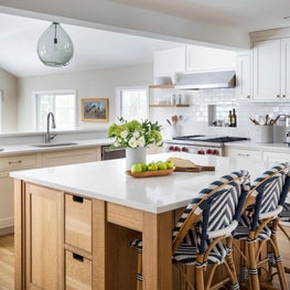 Organic modern oak kitchen island w/ cut out hardware, navy counter stools