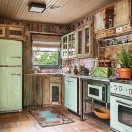 Guest cottage kitchen with mismatched cabinets and vintage inspired appliances
