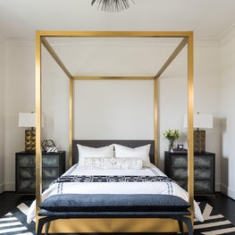 Portfolio: Stunning metallic bed frame and black chandelier add glam and luxury to bedroom