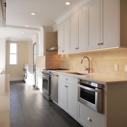 White Prewar Kitchen with Custom Cabinetry & PTAC covers