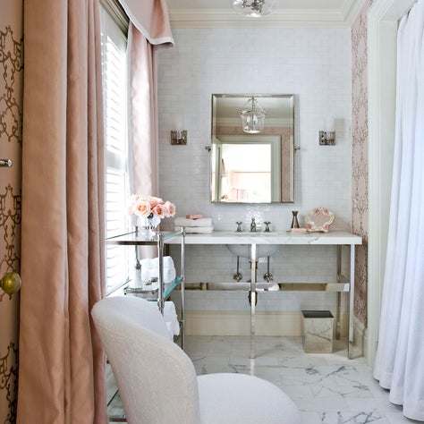At Home toiletry area with marble floors, pink drapes