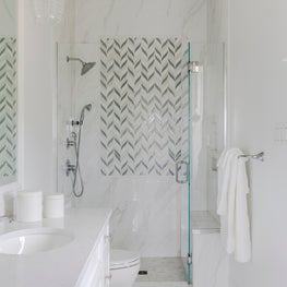 Guest Bathroom with porcelain and marble accents 