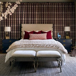 Portfolio: A tailored guest bedroom layers plaid drapery, navy case pieces, and floating Hogwarts acceptance letters for a sophisticated take on Harry Potter.