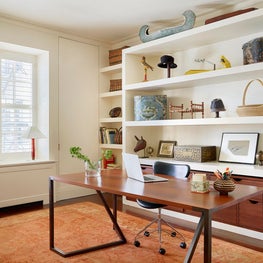 Custom free standing desk & built in shelving showcasing art by Bill Traylor 