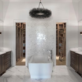 Master Bathroom vignette showcasing his & her vanities as well as soaking tub 