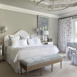 Master bedroom in soft blue palette with custom bedding & monogram finish