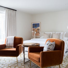 Portfolio: A pair of rust-colored chairs in a bedroom in Pebble Beach, CA.