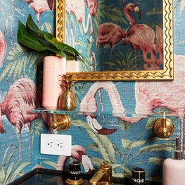 Upper West Side statement powder room with gold accents and flamingo wallpaper