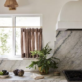 Kitchen with Marble Countertop and Backsplash