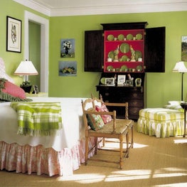  Lime green walls and pops of pink floral fabric create a fun bedroom.