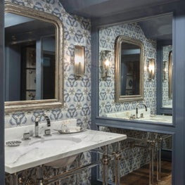 Formal powder room with kaleidoscopic stone wall & custom marble vanity piece