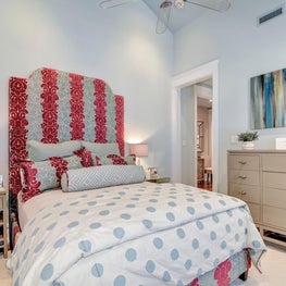 Custom pink and blue headboard and bedding in a beach house
