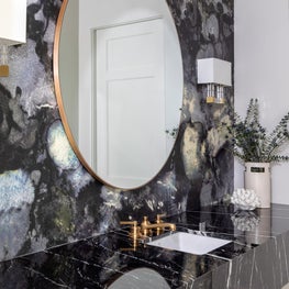 Portfolio: Striking powder room with colorful wallpaper and a black counter