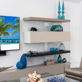 LAKEFRONT CONTEMPORARY VILLA, floating shelves, lucite arm chair, art glass, modern rug, teal blue glass, modern den, modern living room