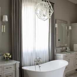 Elements of cool greys & silver bring sophisticated luxury to his & her bathroom