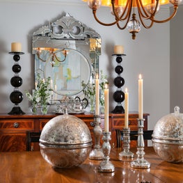 Stylish metallics  brighten up this eclectic dining room.