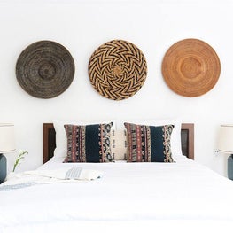 Casual Silver Lake Bedroom with Ethnic Textiles and Wall-Mounted Baskets