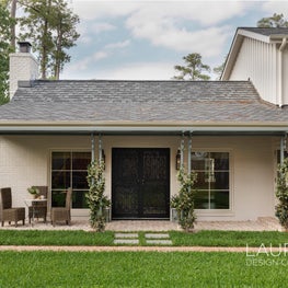 Our renovation team demoed the front porch of this original 1920s hunting lodge to create a fresh and welcoming space.