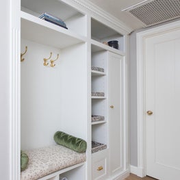 Small Space Solution with Custom Cabinetry for Functional Storage and Seating